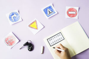 woman writes workbook driving lessons